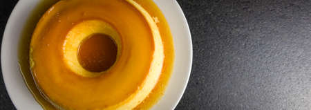 Traditional Brazilian dessert, milk pudding on dark background.の写真素材