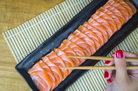 Traditional salmon carpaccio with olive oil sauce and lemon juiceの写真素材