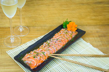 Traditional salmon carpaccio with olive oil sauce and lemon juiceの写真素材