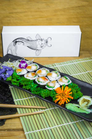 Perfect sushi, traditional Japanese cuisine. Delicious hossomaki on the decorated plateの写真素材