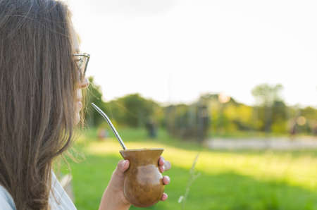 Blonde woman taking traditional gaucho chimarraoの写真素材