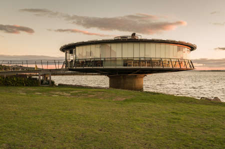 Porto Alegre, Rio Grande do Sul, Brazil, March 29 - 2021: Panoramic restaurant on the GuaÃ­ba waterfront in silhouette at sunset.のeditorial素材
