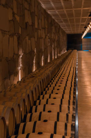 Oak barrels for wine aging in an underground cellar in Vale dos Vinhedos