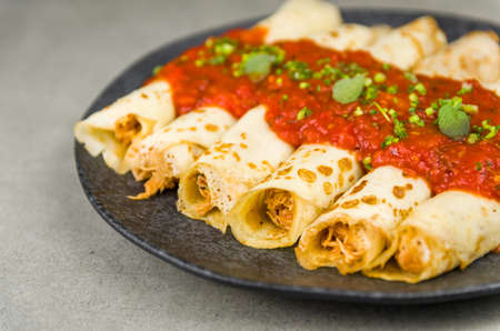 Brazilian pancakes with chicken, tomato bolognese sauce, rolled pancakes.の写真素材