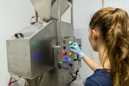 Woman working in industry, adjusting equipmentの写真素材