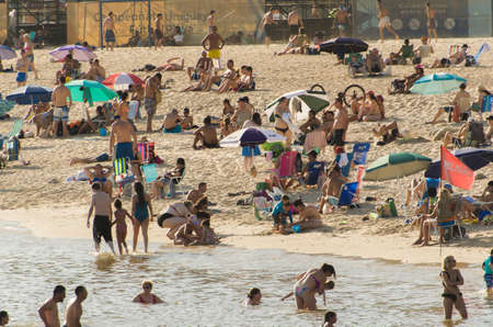 Montevideo, Uruguay - 11th January 2022 - Beautiful sunset on Pocitos beach with bathers on a summer day in Montevideo Uruguay.のeditorial素材