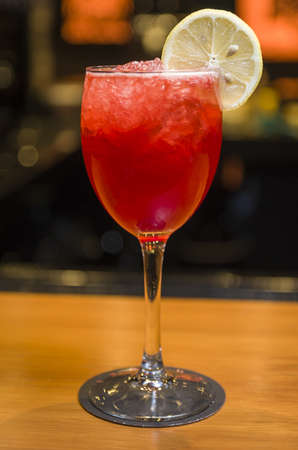 Close-up of delicious drink in glass of red berries, lemon and gin.の写真素材