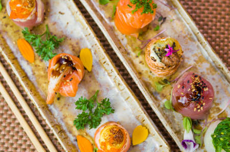 Platter decorated with different flavors of elegant sushi. Selective focus.の写真素材