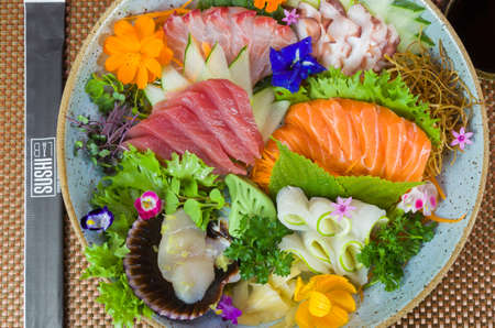 Platter decorated with different flavors of elegant sashimi sushi, salmon, tuna, halibut, burnt salmon. Selective focus.の写真素材