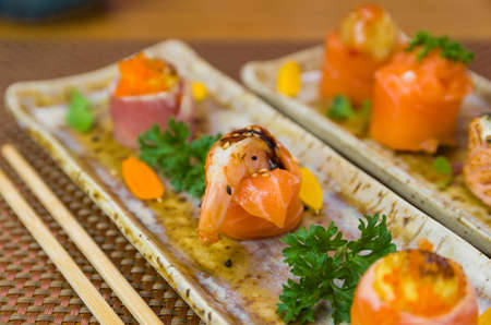 Platter decorated with different flavors of elegant sushi. Selective focus.の写真素材