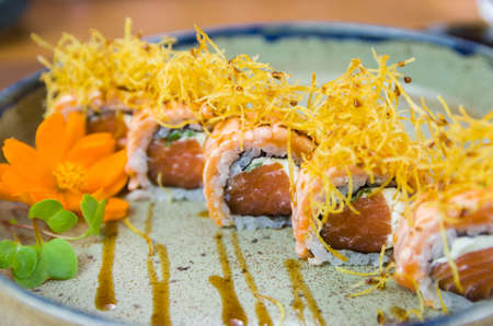 Platter decorated with different flavors of elegant uramaki sushi. Selective focus.の写真素材