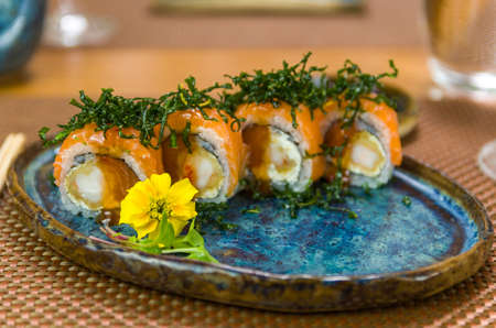 Platter decorated with different flavors of elegant uramaki sushi. Selective focus.の写真素材