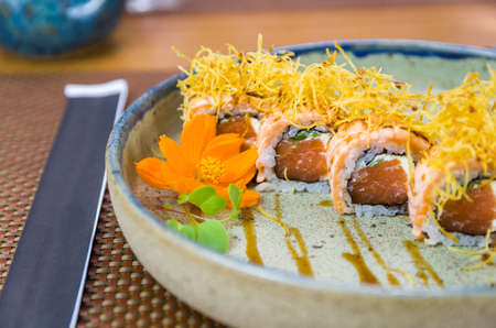 Platter decorated with different flavors of elegant uramaki sushi. Selective focus.の写真素材