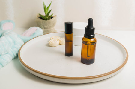 Cosmetic packaging. Set of different cosmetics on plate with decoration. Skin care concept.
