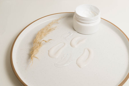 Cosmetic smears of creamy texture on a beige background.