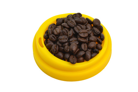 Coffee beans on yellow coffee lid.の写真素材