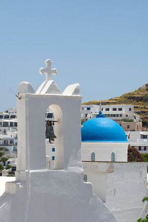 Greece, the island of  Ios. A church bell tower and the blue dome of another church in the old town; the hora.の写真素材