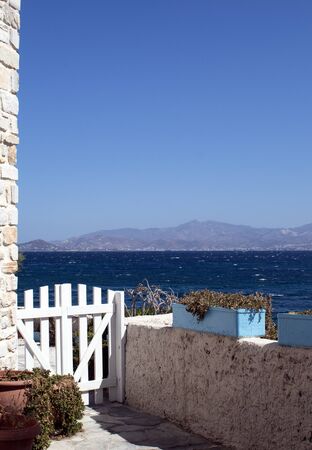 Greece the island of Paros. A view of the neighbouring island of Naxos from the resort of Piso Livardi. Clear blue skies on a late summers day.の写真素材