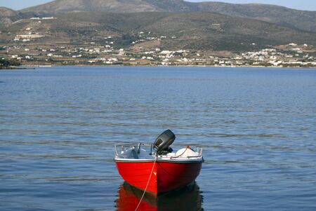 Greece â a red row boat moored. The island of Antiparos in the Aegean sea.の写真素材