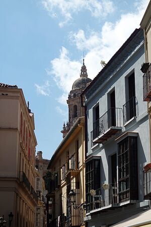 Downtown Malaga. Medieval streets that lead to the main focus of the ancient city, the Cathedral.  In the distance, above the rooftops, is the north tower of that fine building.の写真素材
