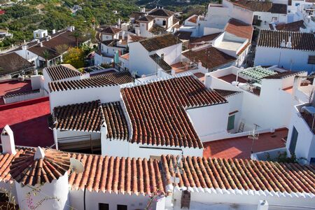 A view of the brighly coloured rooftops at the beautiful Spanish village of Frigiliana. Located near the resort of Nerja on the Costa Del Sol, it is a typical whitewashed town of Moorish origin.の写真素材