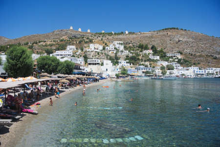 Leros / Greece / August 28 2014 : Landscape of a beautiful beach at the charming Greek island of Leros. Holiday makers enjoy the summer sun.のeditorial素材