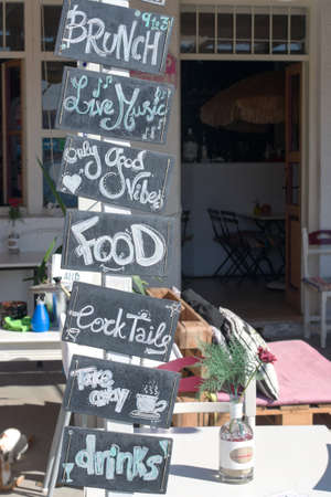 Greek island Taverna, Ios island Menu board advertising drinks and snacks at a relaxed pavement cafe at the harbor of this beautiful islandのeditorial素材
