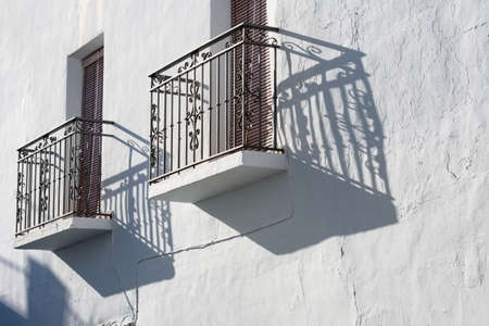 Frigiliana, Spain. Traditional Spanish village house. Close up view of typical Juliet balconies. Costa del Sol hill town.  Landscape aspect with copy spaceの写真素材