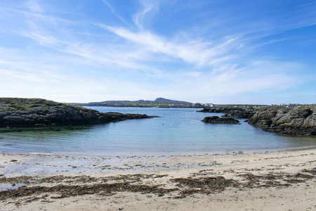 Treaddur Bay, Anglesey, Wales. Beautiful seascape of a rocky small cove, with a secluded beach. Charming summer scene. Blue sky and copy space.の写真素材