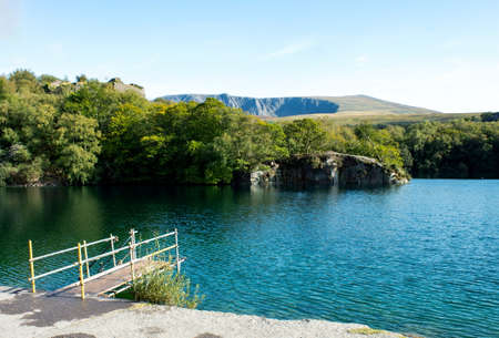 Beautiful Dorothea quarry, Snowdonia, Wales. Peaceful landscape with forest, lake and a small jetty...