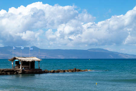 Crete island, Greece Agia Marina beach near Chania Small rock breakwater with cliffs and mountains on the horizonの写真素材