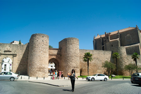Ronda - Spain - August 15 2012 :  Dramatic medieval city walls. Defensive Almocabar gate. Stone historic landmark.のeditorial素材