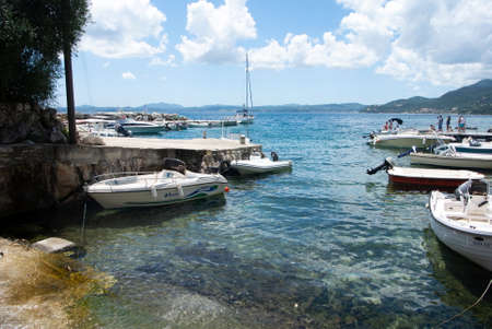 Nissaki, -  Greece - July 10 2014 : Small boats at .beautiful Corfu, island. Tranquil summer scene at a preety small bay.  Landscape aspect view.のeditorial素材