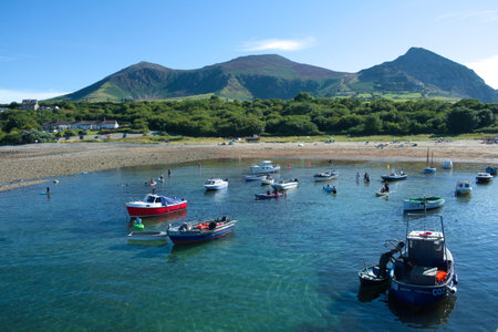 Trefor, Wales - Britain - August 9 2012 : British seaside, A small village on the Welsh Llyn Peninsula,  Beach scene,  peaceful summer landscape. Small boats at low tide.のeditorial素材