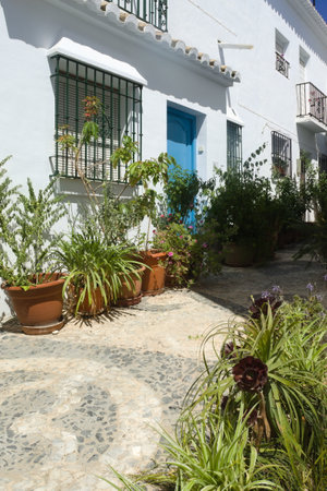 Frigiliana, Nerja -  Spain - June 22 2022 : Flowers in a traditional historic alley in the heart of the Moorish village. Portrait aspect shot.のeditorial素材