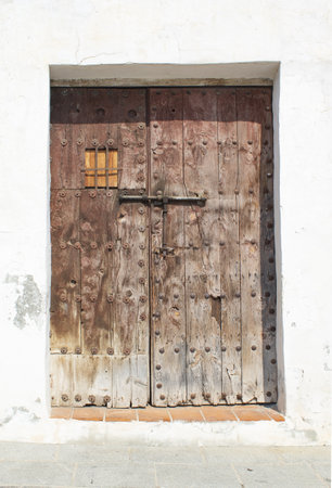Ancient weathered doorway in the village of Frigiliana in southern Spain.  Close up detailed view of traditional old structure.の写真素材