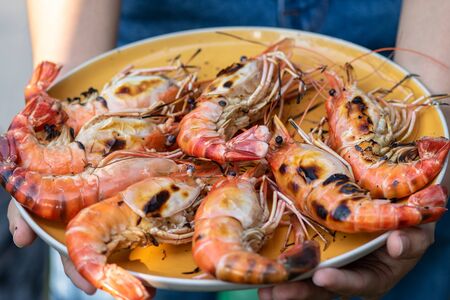 Fresh river prawn grilled on large dishes Local food. Cooking at home. selective focus. Big shrimps.の写真素材