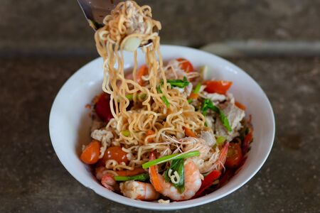 Yum Instant Noodles Shrimp Fresh Thai style food of instant noodles salad with pork, herbs and...