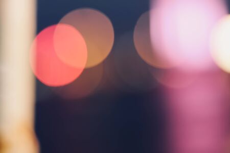 Red, blue, pink, orange, yellow and bokeh lights in front of the harbor.