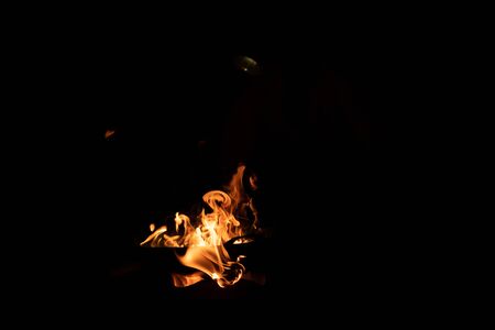 Red orange flame from the fire on the pan roasting cashews.fire,heat energy that ignites fuel at...