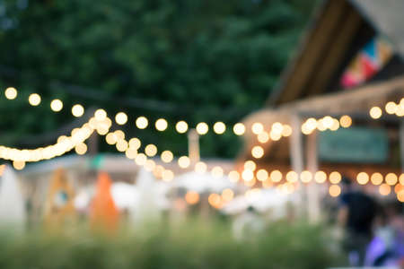 Blur the lights on the beach restaurant in Siracha, Thailand. Blurred cafe background with bokeh. Bright sea view. abstract blur of coffee cafe shop.orange ,red, light.の写真素材