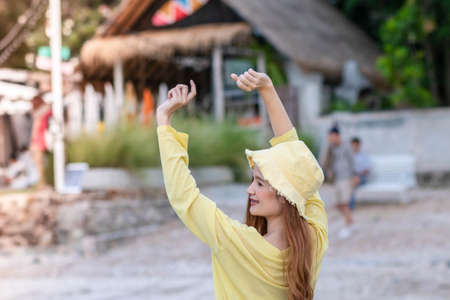 Young woman relaxing in summer sunset sky outdoor. People freedom style. Young woman stretching arms...