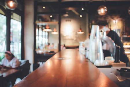 Blur coffee shop or cafe restaurant with abstract bokeh light image background.For montage product display or design key visual layout. Abstract defocused bokeh. orange, red, light. vintage effect.の写真素材