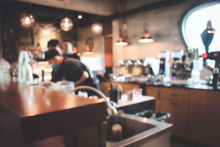 Blur coffee shop or cafe restaurant with abstract bokeh light image background.For montage product display or design key visual layout. Abstract defocused bokeh. orange, red, light. vintage effect.の写真素材