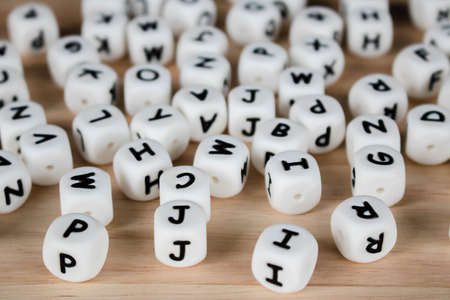 Text dice cube concept / Letter dices alphabet on wooden background. Block of alphabet studded on...