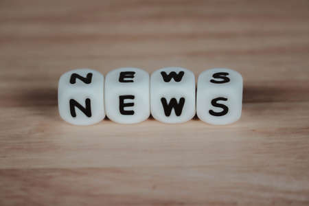 Wooden dice depicting the letters NEWS word conceptの写真素材