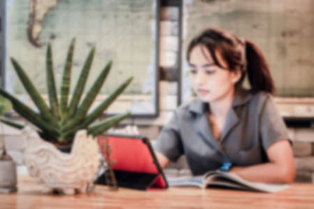 Blurred background : Attractive young woman working office with new freelance business startup. film effect ,reflections, bokeh, vintage filter.の写真素材