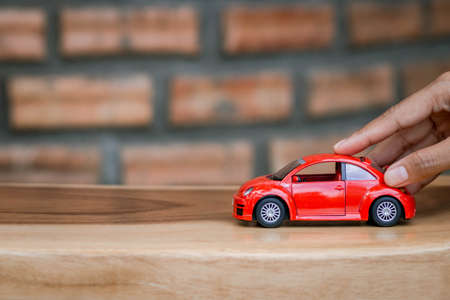 Chon buri, Thailand, September 07 , 2020. Car purchase concept. Toy car on woman's palm, Brick wall background. Vintage style. copy space.のeditorial素材
