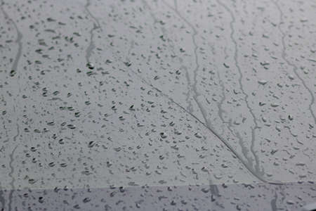 Rain on the surface of the window Stop and flow into the rain. With cloudy backgrounds, natural patterns of isolated raindrops. black and white background.の写真素材