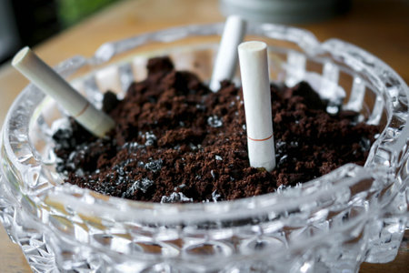 Ashtray with extinguished cigarettes full of ashes. No people.の写真素材